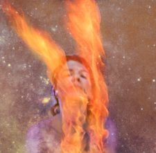 Artistic picture of a woman in on fire, with the universe behind her