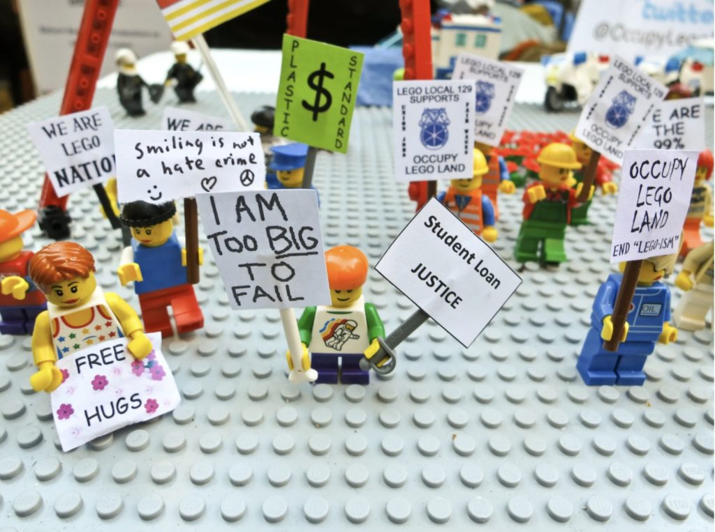 Tiny plastic protesters hold up signs in Occupy Lego Land, a diorama at Occupy Wall Street.