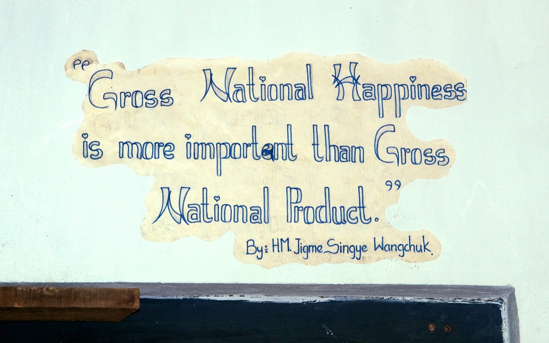 Slogen saying Gross National Happiness is more important than Grosss National Product