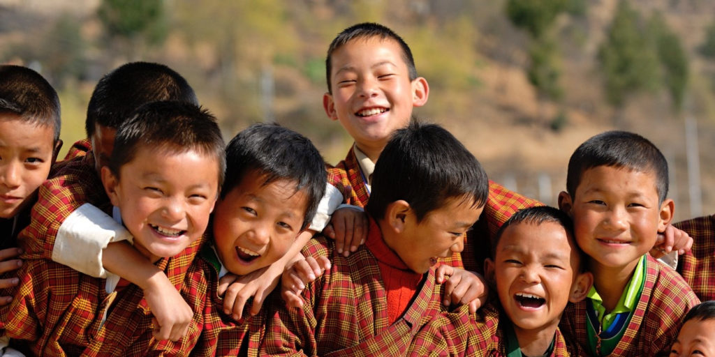 Many Happy children in Bhutan smiling into the camera