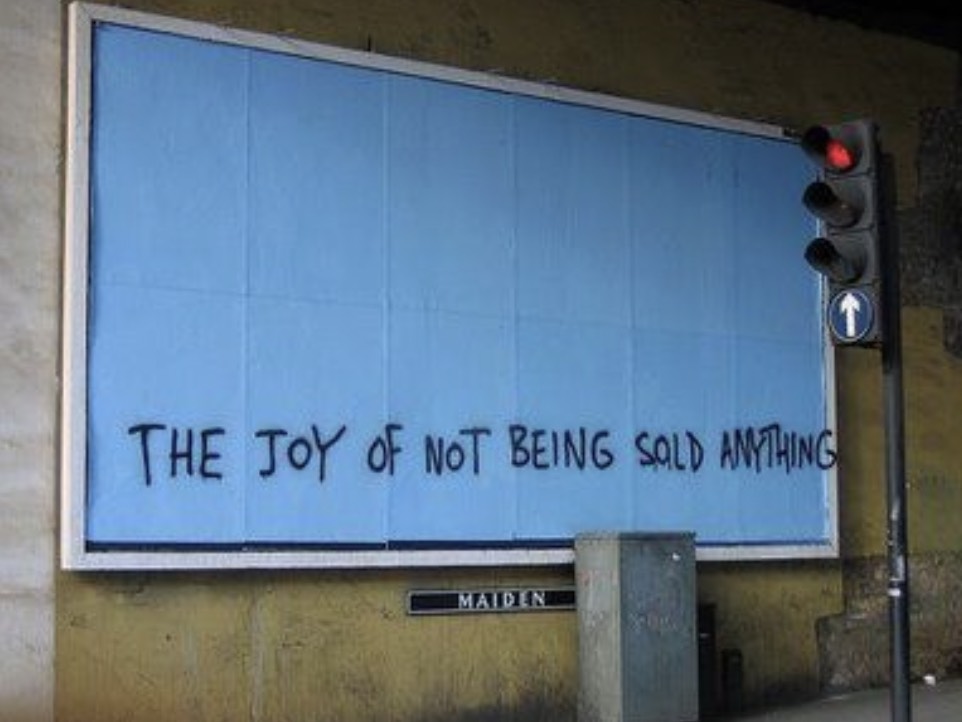A billboard with no ad on it, just a graffiti saying the joy of not consuming anything