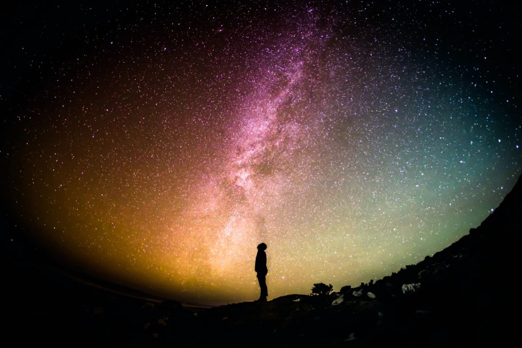 Boy silueta standing in front of stars